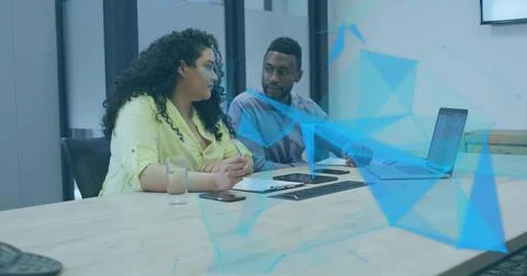Writing on notepad with pen, two professionals in business attire sitting in  Stock Photos