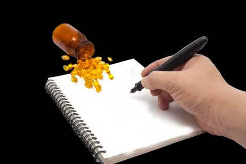 Writing notes and fish oil 写真素材