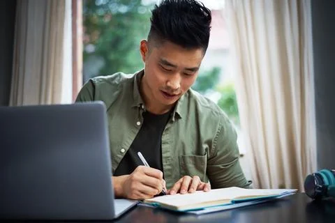 Writing notes, hybrid work and Asian man in home office, idea or social med.. Stock Photos