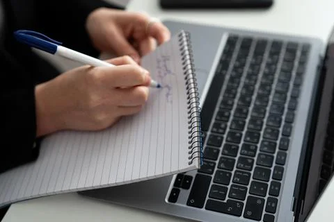 Writing Notes on Laptop Keyboard Close-Up Stock Photos