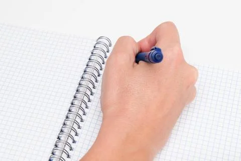 Writing notes or planning a schedule on blank spiral notebook, hand using a pen Stock Photos