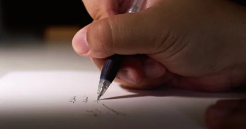 Writing numbers while solving a math problem using a blue pen and paper. Stock Footage 281263346