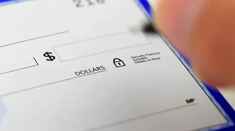 Writing out a check for an amount plus signing Stock Footage