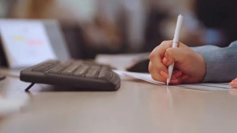 Writing with a pen and working on a computer Stock Footage 277830442