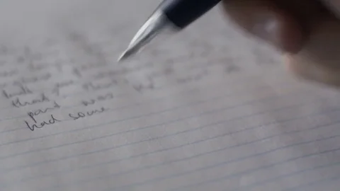 Writing with a pen on lined sheet of paper. Stock Footage 73270624