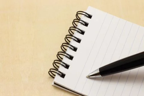 Writing pen on the notepad Stock Photos
