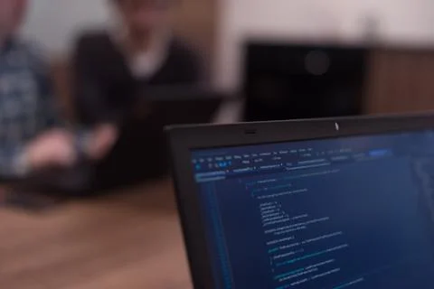 Writing programming code on laptop Stock Photos