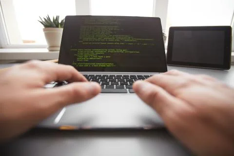 Writing programming code on laptop Foto stock