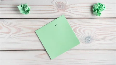 Writing question mark on green sticker sticky note, crumpling notes, drawing Stock Footage 232383611