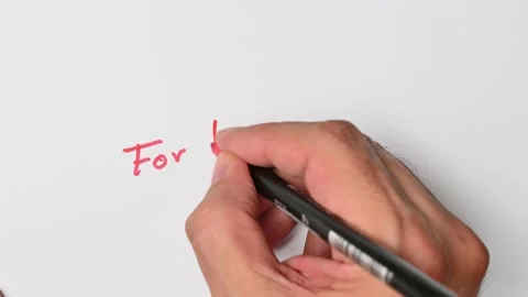 Writing with a red marker the sentence: For the birds Stock Footage 221783060