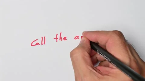 Writing with a red marker the sentence: Call the ambulance Stock Footage 221781210