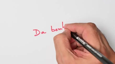 Writing with a red marker the sentence: Da bomb Stock Footage 221782432