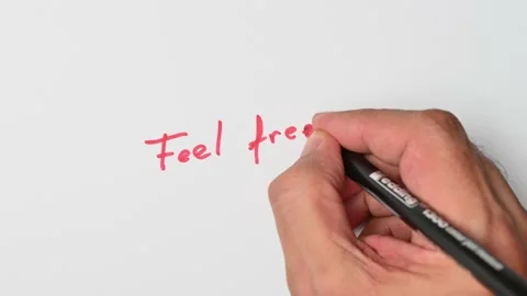 Writing with a red marker the sentence: Feel free Stock Footage 221782798