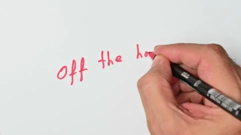 Writing with a red marker the sentence: Off the hook Stock Footage 221782661