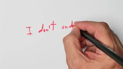 Writing with a red marker the sentence: I don’t understand Stock Footage 221780877