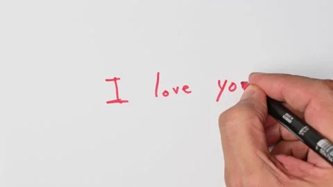 Writing with a red marker the sentence: I love you Stock Footage 221781318