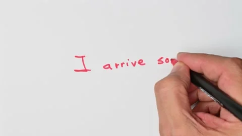 Writing with a red marker the sentence: I arrive soon Stock Footage 221781340