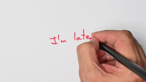 Writing with a red marker the sentence: I’m late Stock Footage 221781348