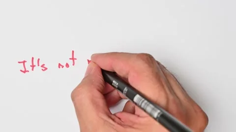 Writing with a red marker the sentence: It’s not my business Stock Footage 221782292