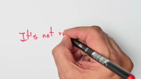 Writing with a red marker the sentence: It’s not rocket science Stock Footage 221782877