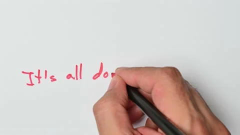 Writing with a red marker the sentence: It’s all downhill from here Stock Footage 221783818