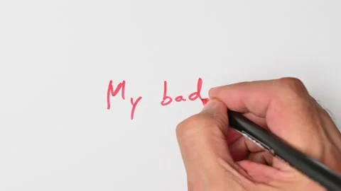 Writing with a red marker the sentence: My bad Stock Footage 221782012
