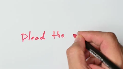 Writing with a red marker the sentence: Plead the Fifth Stock Footage 221783743