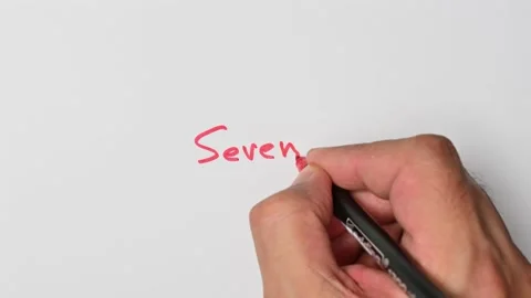 Writing with a red marker the sentence: Seven Stock Footage 221783979