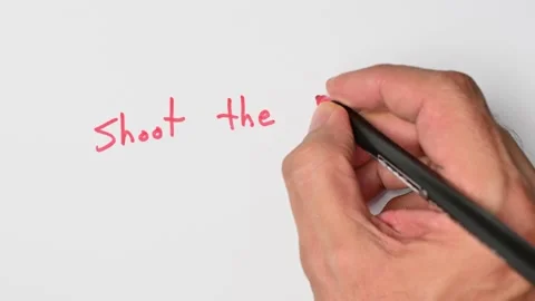 Writing with a red marker the sentence: Shoot the breeze Stock Footage 221783057