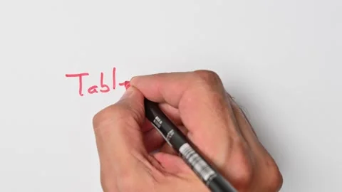 Writing with a red marker the sentence: Table an item Stock Footage 221783482