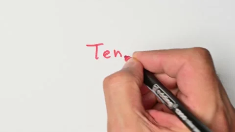 Writing with a red marker the sentence: Ten Stock Footage 221784022