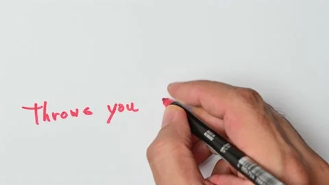 Writing with a red marker the sentence: Throws you under the bus Stock Footage 221783810