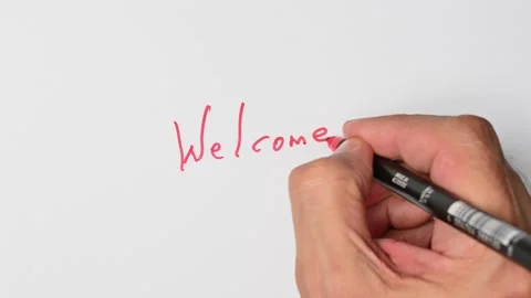 Writing with a red marker the sentence: Welcome Stock Footage 221780759