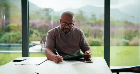 Writing, remote work or black man with tablet in home, accounting audit or Stock Footage 335512219
