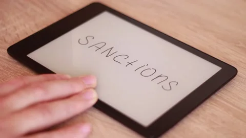 Writing SANCTIONS on Electronic tablet Stock Footage 166210084