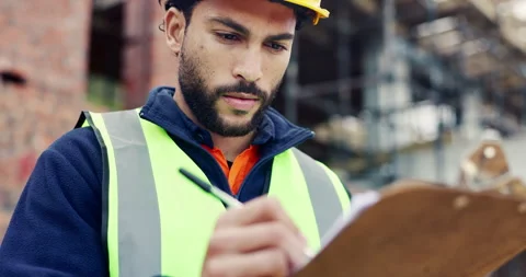 Writing, smile or man with checklist at construction site, property framing or Stock Footage 336795659
