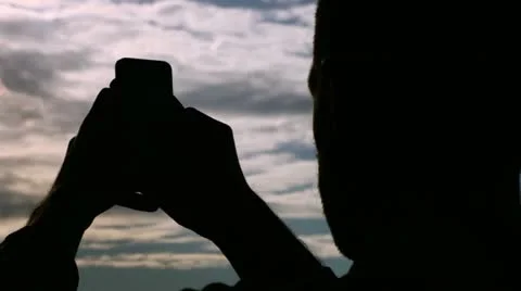 Writing sms/email on smartphone in backlight. Stock Footage 10907982
