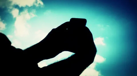Writing sms/email on smartphone in backlight Stock Footage 35281149