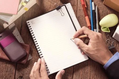 Writing something on the book Stock Photos