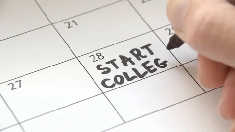 Writing START COLLEGE on calendar with a black marker Stock Footage 80486205