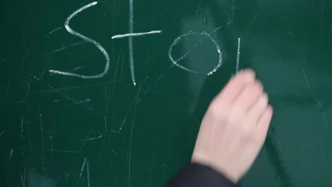 Writing Stop with chalk on greenboard Stock-Footage 170904439
