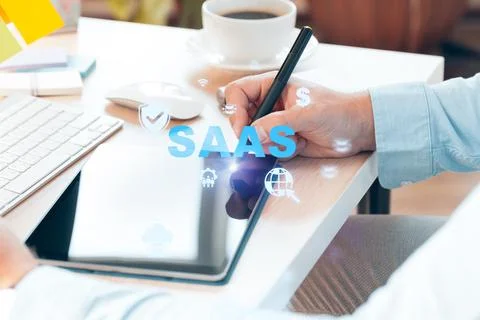 Writing on tablet while exploring Saas solutions in an office setting Stock Photos