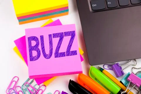 Writing text showing Buzz made in the office with surroundings such as laptop Stock Photos