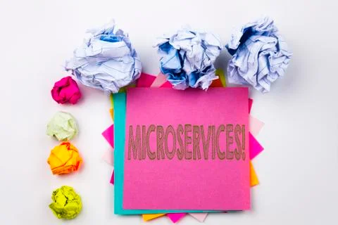 Writing text showing Microservices written on sticky note in office with scre Stock Photos
