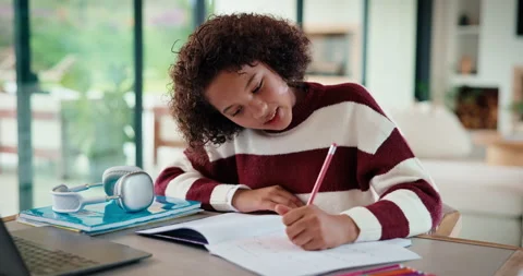 Writing, thinking and child in house with homework for elearning, online class Stockbeeldmateriaal 335795444