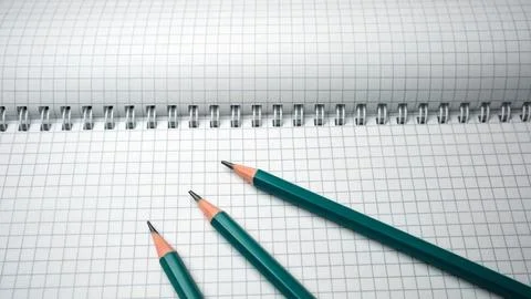 Writing tools ready for creativity on a fresh notebook page Stock Photos