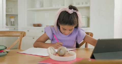Writing tween in purple top tapping tablet seeing headset, putting on for Stock Footage 340011436