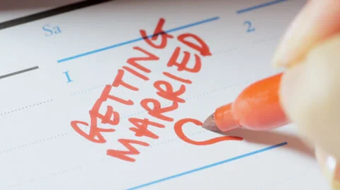 Writing wedding date on calendar Stock Footage 33821986