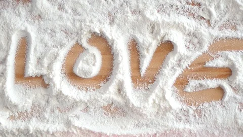 Writing word love on table full of flour Stock Footage 88411916