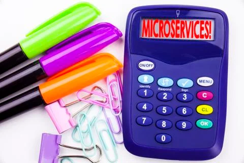 Writing word Microservices text in the office with surroundings such as marke Stock Photos